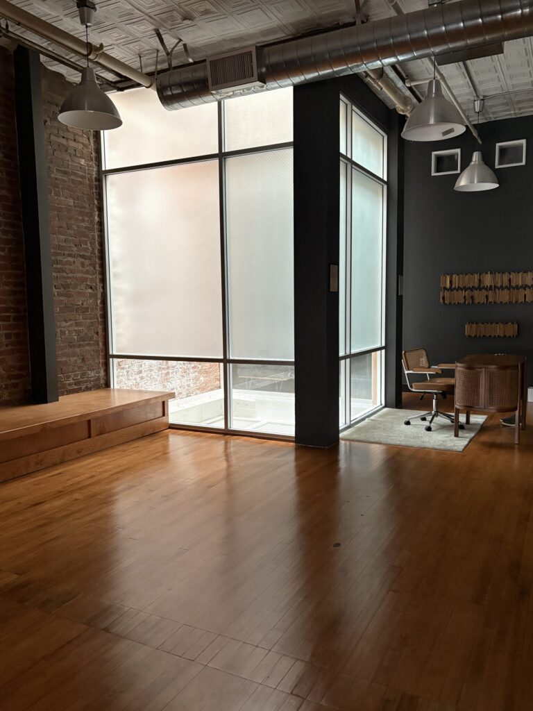 unique glassed-in elevator shaft casts stunning light into the studio entryway