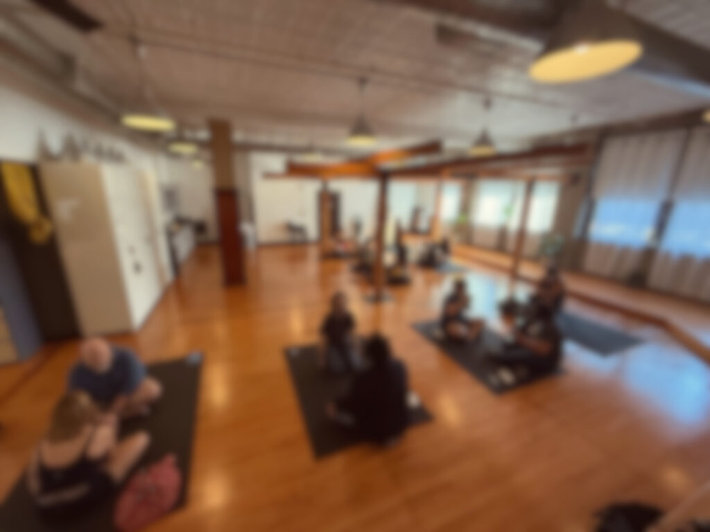 people sit on floors on mats throughout our spacious Downtown Los Angeles studio