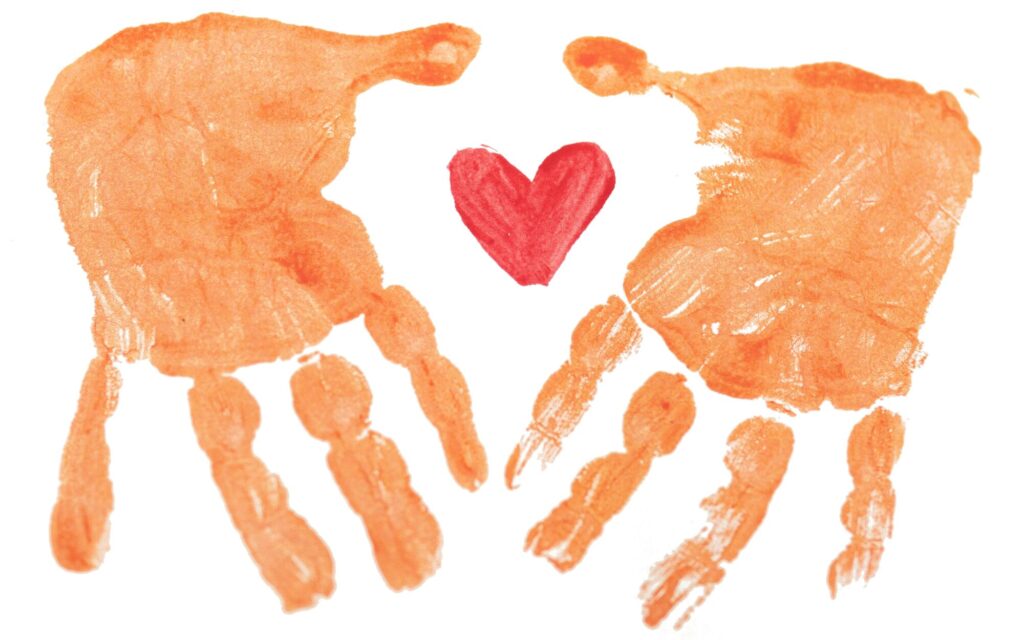 Finger-painted hand prints surround a small heart symbolizing care